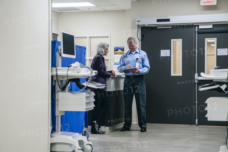 Doctors using digital tablet in hospital