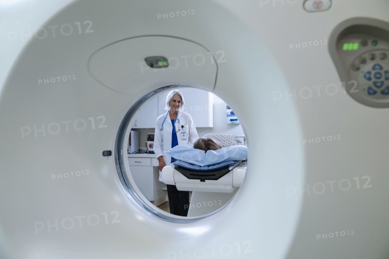 Caucasian doctor comforting patient near scanner