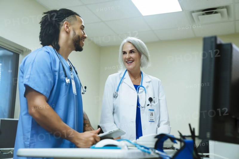 Smiling doctor and nurse talking
