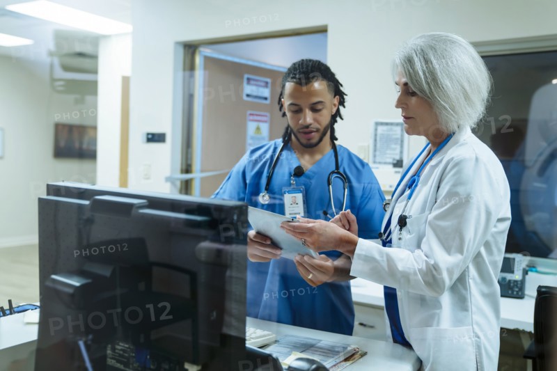 Doctor and nurse discussing digital tablet