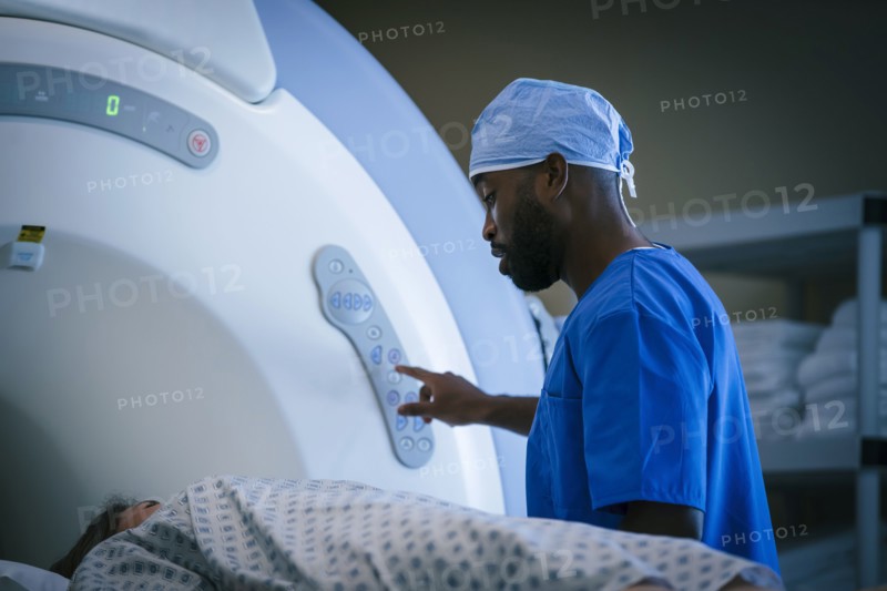 Technician talking to patient at scanner