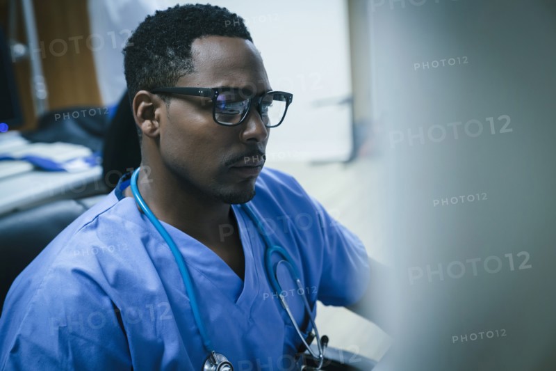Black nurse using computer