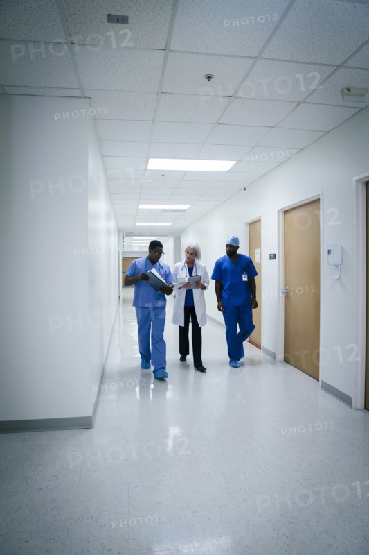 Doctor and nurses discussing paperwork in hospital