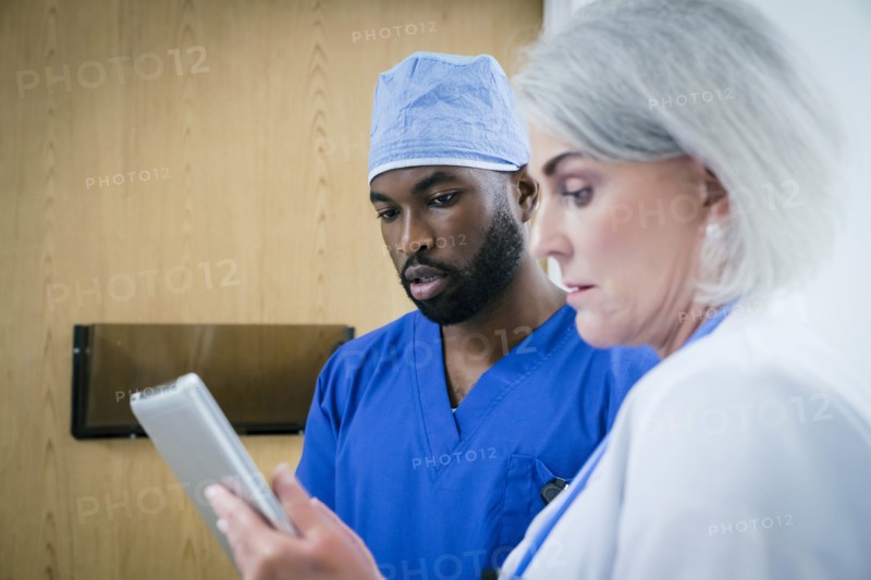 Doctor and nurse discussing digital tablet