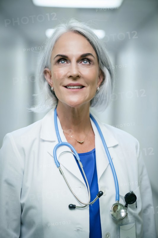 Smiling Caucasian doctor looking up