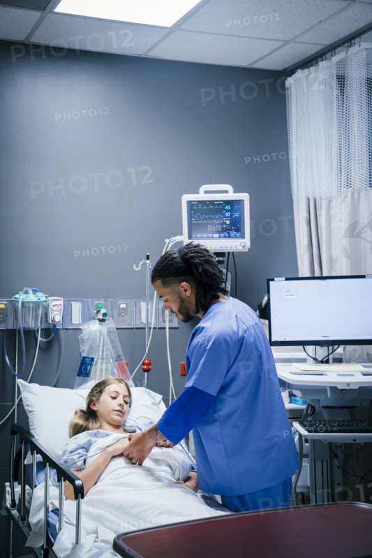 Nurse holding hand of patient in hospital