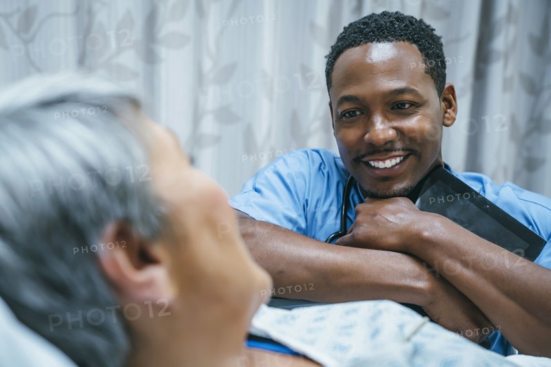Nurse talking to patient in hospital bed