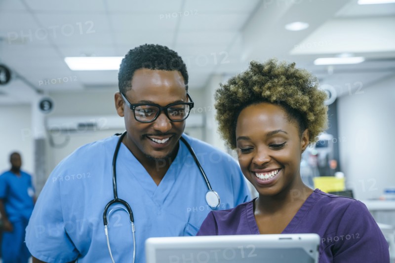 Smiling black nurses using digital tablet