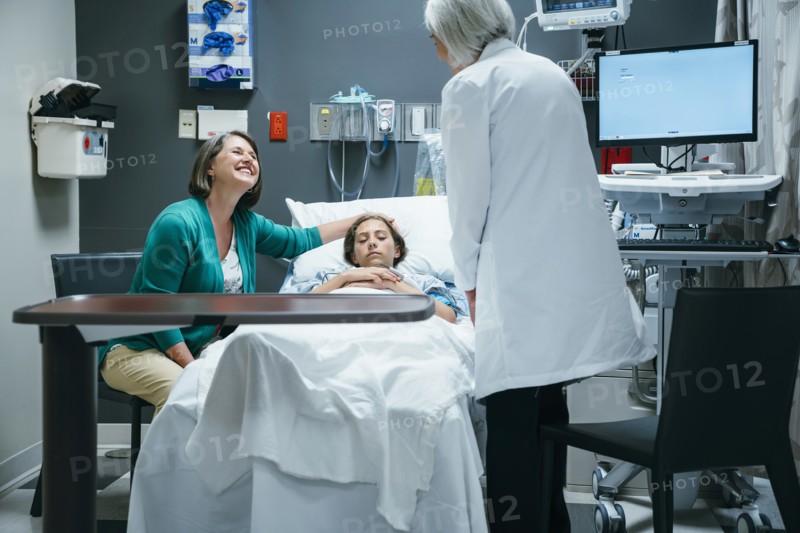 Caucasian doctor talking to mother and daughter in hospital