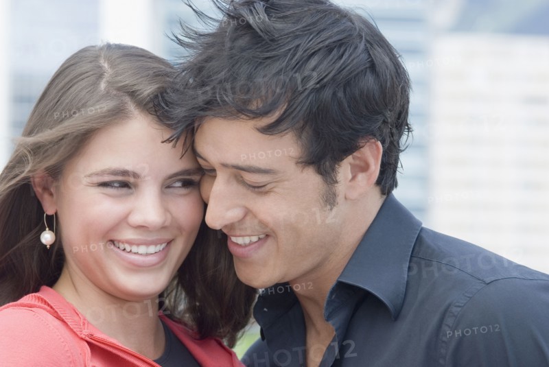 Hispanic couple hugging outdoors