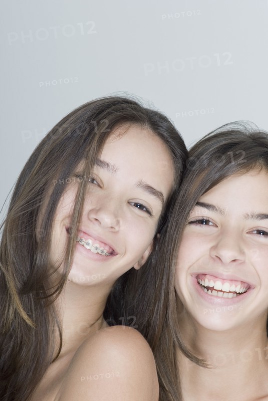 Two Hispanic teenage girls smiling