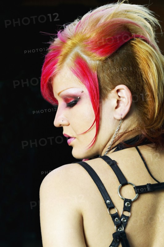 Rear view of young Hispanic woman with punk hair and clothing