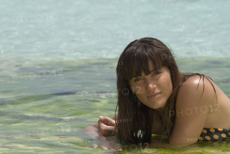 Young woman laying in water