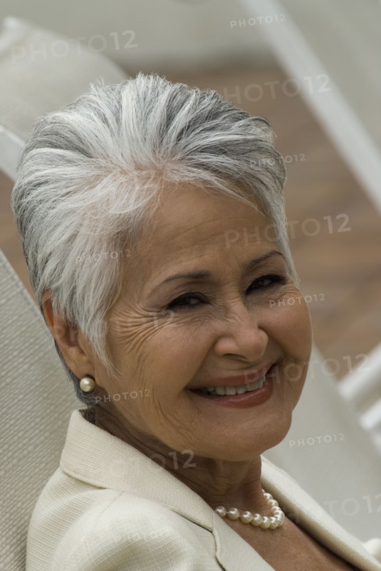 Senior Hispanic woman in lounge chair
