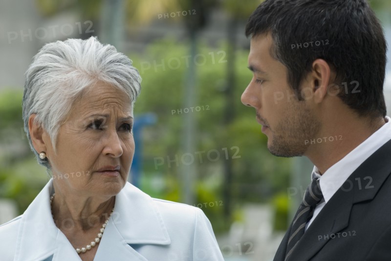 Hispanic mother and adult son talking