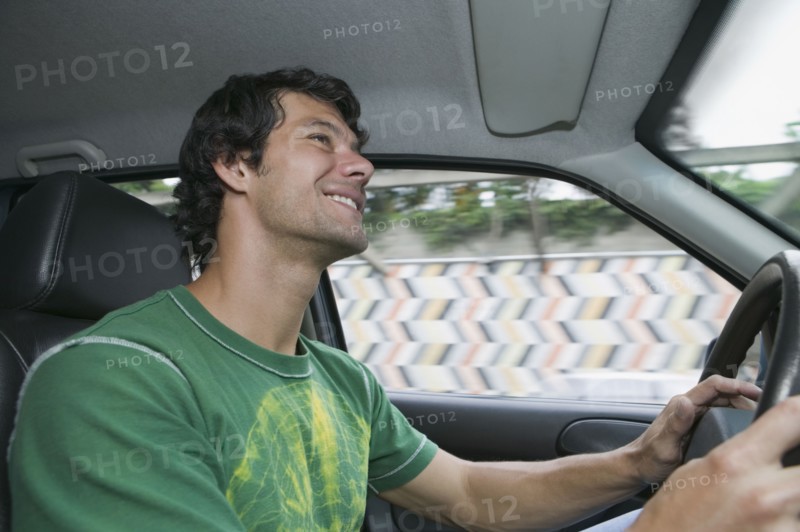 Hispanic man driving car
