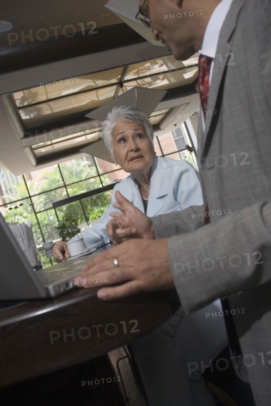Hispanic businesspeople in cafe