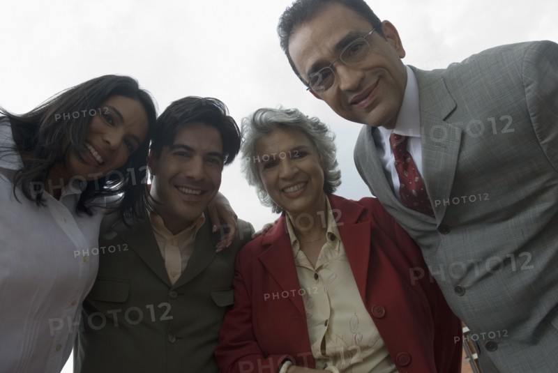 Hispanic businesspeople in huddle