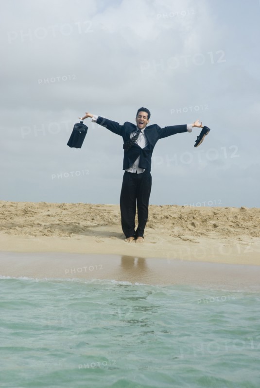 Hispanic businessman at beach