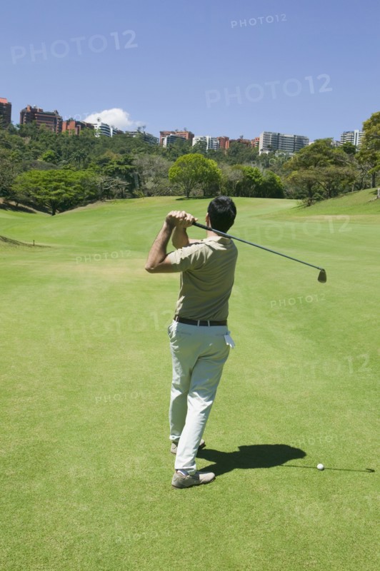 Hispanic man playing golf