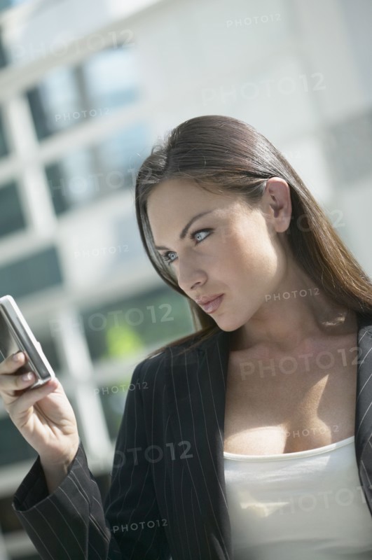 Italian businesswoman looking at cell phone