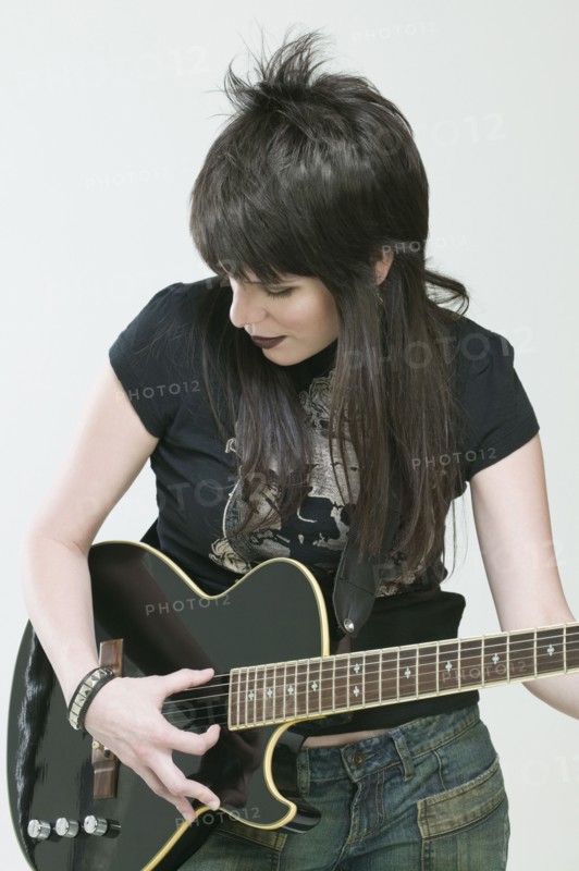 Hispanic woman playing guitar