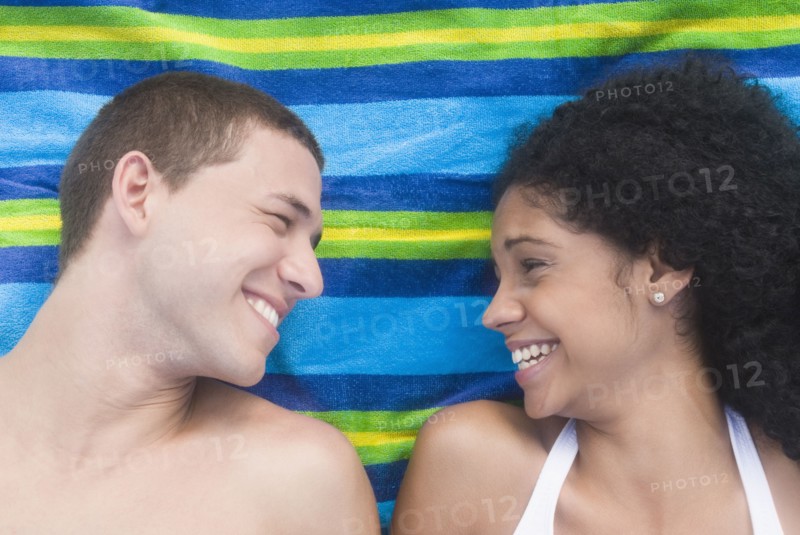 Multi-ethnic couple relaxing at beach