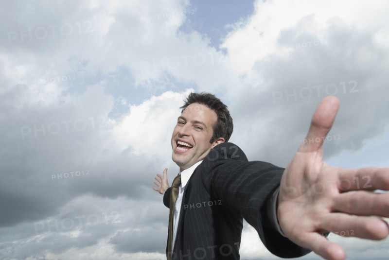 Hispanic businessman with arms outstretched