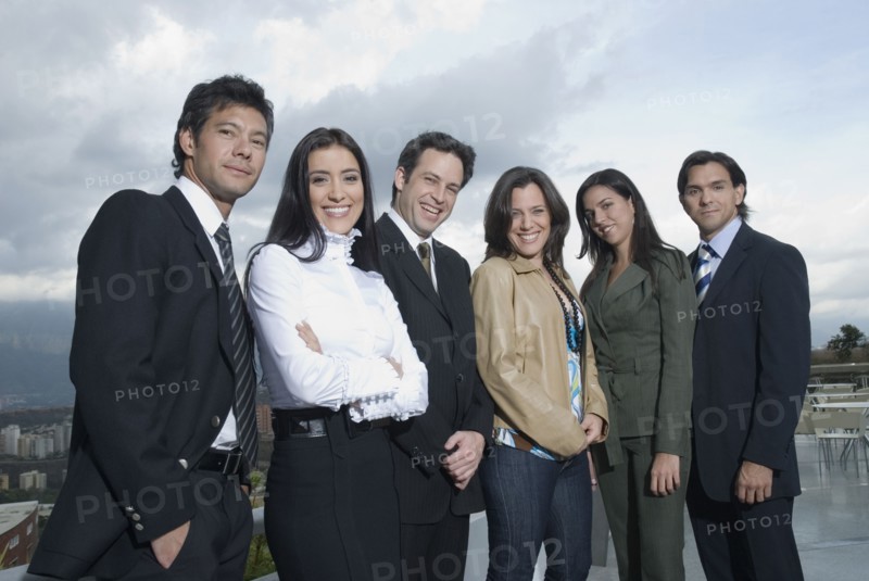 Hispanic co-workers standing in row