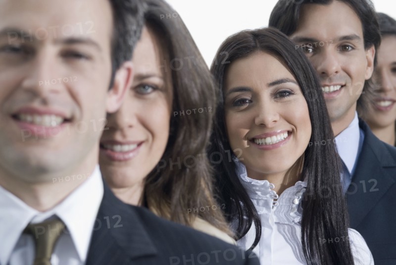 Hispanic co-workers standing in row