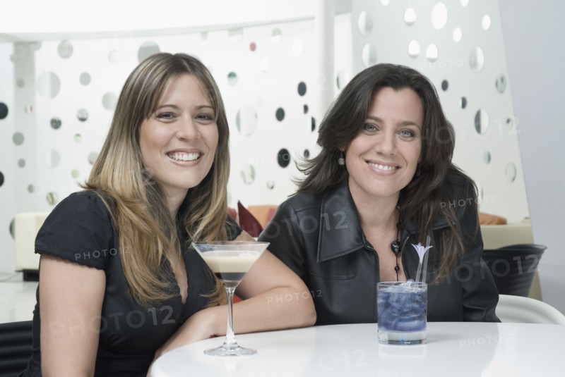 Hispanic friends drinking cocktails