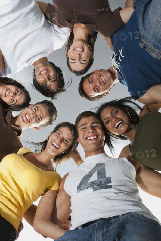 Smiling friends in huddle together