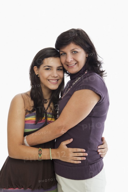 Hispanic mother hugging daughter