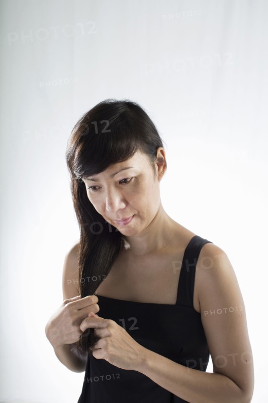 Mixed race woman twisting her hair