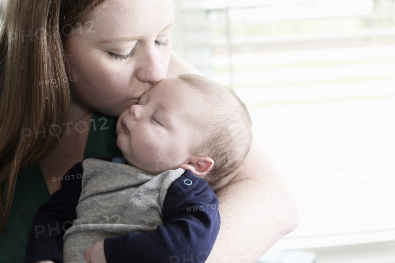 Mother kissing baby son