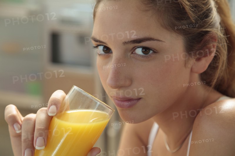 Caucasian woman drinking orange juice