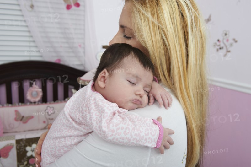 Hispanic mother holding baby daughter