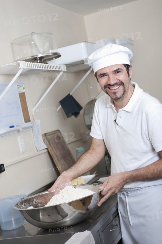 Hispanic baker working in commercial kitchen