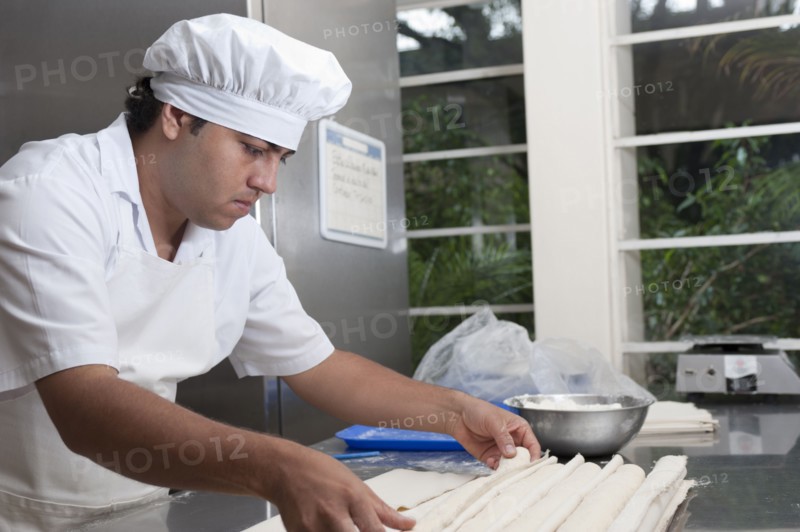 Hispanic baker working in commercial kitchen