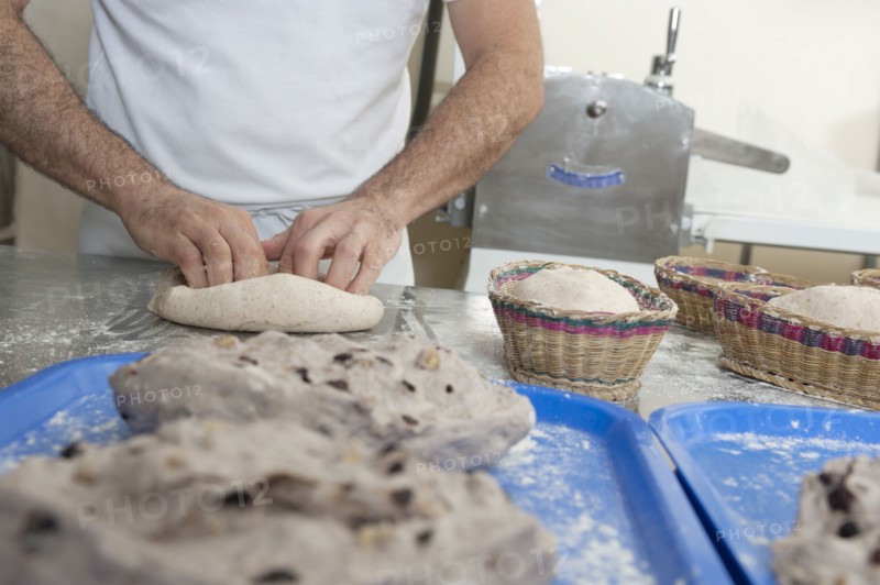 Hispanic baker working in commercial kitchen