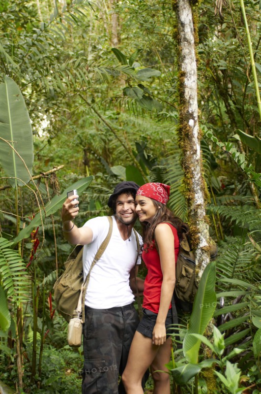 Hispanic couple talking self-portrait in forest