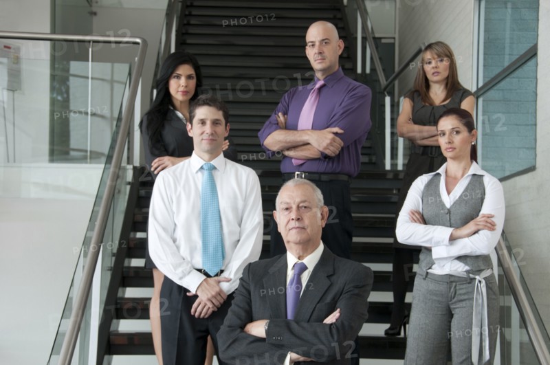 Hispanic business people standing together on staircase