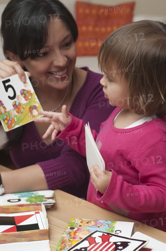 Hispanic mother teaching daughter numbers