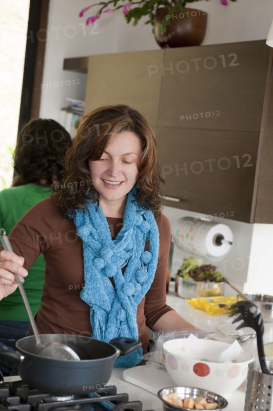 Hispanic family cooking in kitchen