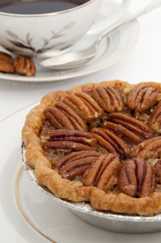 Small pecan pie and cup of coffee