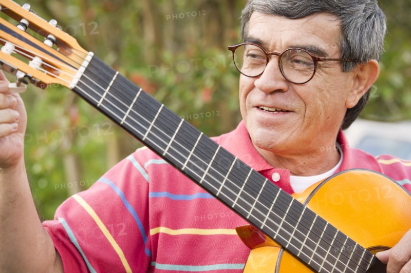 Hispanic man playing guitar