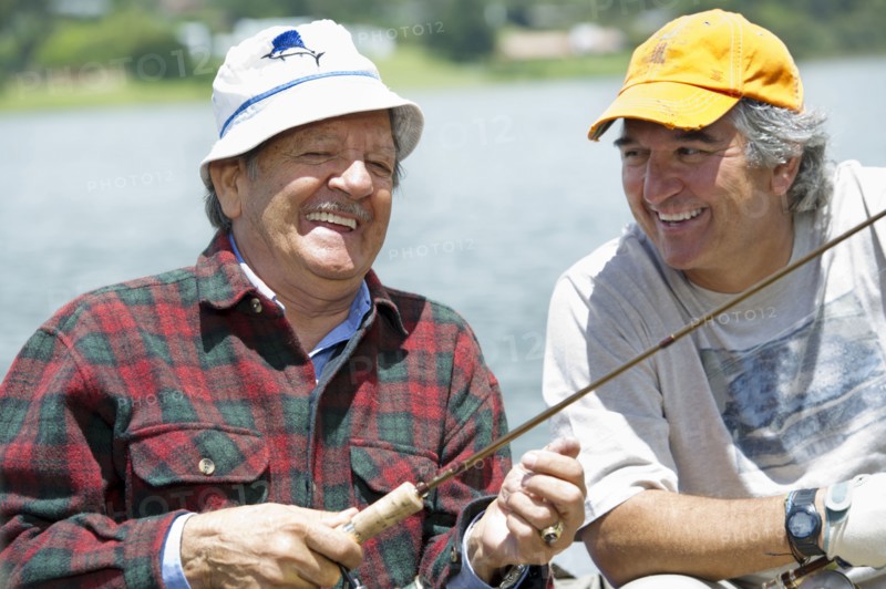 Hispanic men fishing in lake