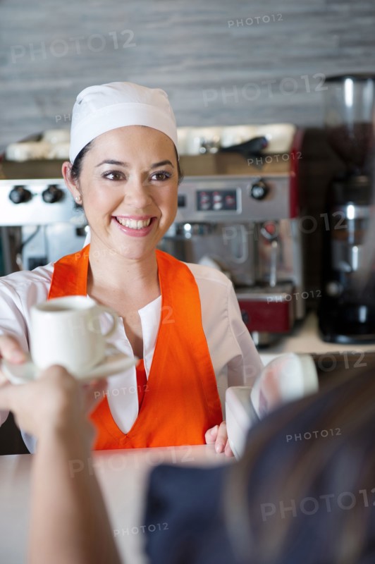 Hispanic woman working in cafe
