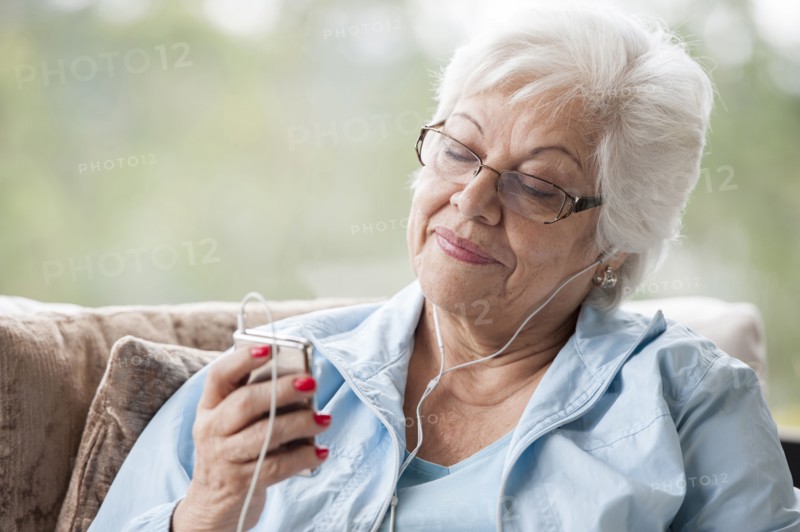 Hispanic woman listening to mp3 player