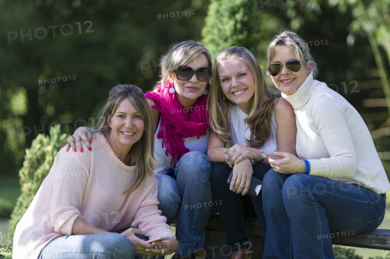 Smiling friends posing outdoors